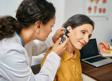 istockphoto-1325611798-612x612 Hearing exam for elderly citizen people. Otolaryngologist doctor checking mature woman's ear using otoscope or auriscope at medical clinic